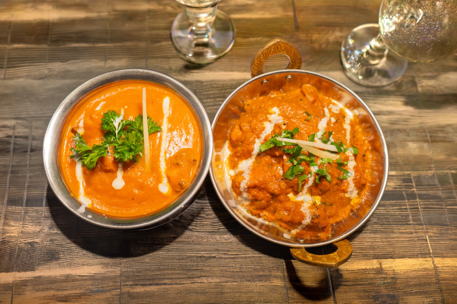 Two curries served in traditional karahi dishes at Madras Eatery