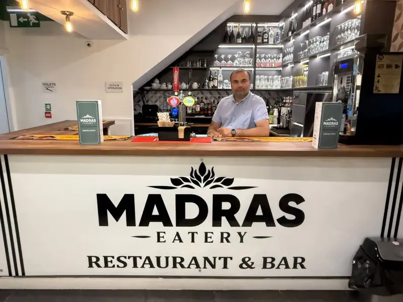 The owner of Madras Eatery behind the bar at his Birmingham restaurant