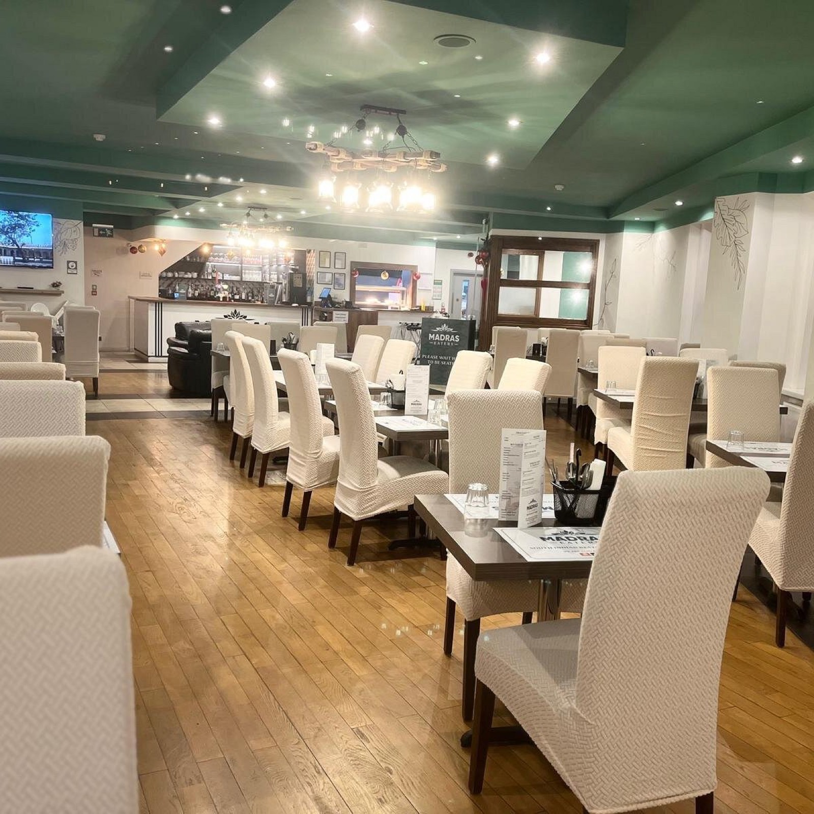 The dining room at Madras Eatery laid up for service